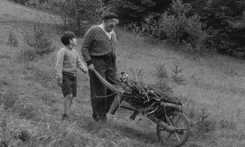 Movie still from “The Two of Us” (1967), directed by Claude Berri – An old photo of a man and a boy pulling a cart of wood; Wide shot, High angle