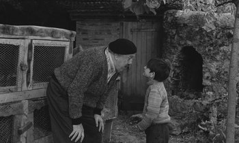 Movie still from “The Two of Us” (1967), directed by Claude Berri – An old man and a young boy are talking to each other; Medium shot, Over the shoulder angle