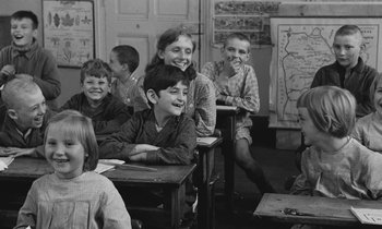 Movie still from “The Two of Us” (1967), directed by Claude Berri – A black and white photo of a group of children in a classroom; Medium shot, High angle