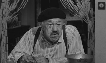 Movie still from “The Two of Us” (1967), directed by Claude Berri – An old man wearing a black hat and a striped shirt; Close Up shot, High angle