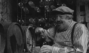 Movie still from “The Two of Us” (1967), directed by Claude Berri – An older man holding a bottle of beer in his hand; Close Up shot, High angle