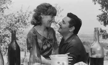 Movie still from “The Two of Us” (1967), directed by Claude Berri – A man and a woman sitting at a table; Medium shot, Low angle