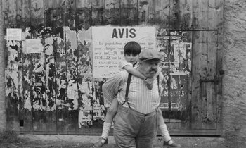 Movie still from “The Two of Us” (1967), directed by Claude Berri – An older man carrying a young boy on his back; Medium shot, High angle