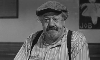 Movie still from “The Two of Us” (1967), directed by Claude Berri – An older man wearing a hat and suspenders; Close Up shot, High angle