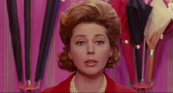 Movie still from “The Umbrellas of Cherbourg” (1964), directed by Jacques Demy – A person wearing a red jacket; Close Up shot, Low angle