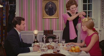 Movie still from “The Umbrellas of Cherbourg” (1964), directed by Jacques Demy – A man and a woman sitting at a dinner table; Wide shot, High angle