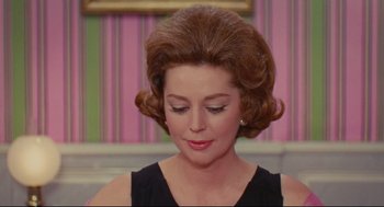 Movie still from “The Umbrellas of Cherbourg” (1964), directed by Jacques Demy – A person wearing a black dress; Close Up shot, Low angle