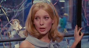 Movie still from “The Umbrellas of Cherbourg” (1964), directed by Jacques Demy – A person with long hair; Close Up shot, Over the shoulder angle