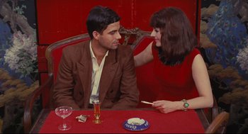 Movie still from “The Umbrellas of Cherbourg” (1964), directed by Jacques Demy – A man and a woman sitting at a dinner table; Medium shot, Overhead angle