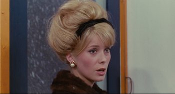 Movie still from “The Umbrellas of Cherbourg” (1964), directed by Jacques Demy – A person wearing a fur coat; Close Up shot, Over the shoulder angle
