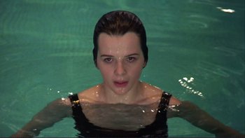Movie still from “The Unbearable Lightness of Being” (1988), directed by Philip Kaufman – A woman is swimming in a pool of water; Close Up shot, High angle