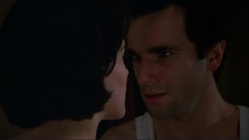 Movie still from “The Unbearable Lightness of Being” (1988), directed by Philip Kaufman – A man and a woman face to face in the dark; Close Up shot, Over the shoulder angle