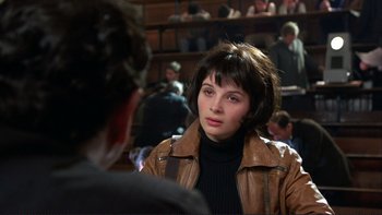 Movie still from “The Unbearable Lightness of Being” (1988), directed by Philip Kaufman – A woman wearing a brown leather jacket talking to a man; Close Up shot, Over the shoulder angle