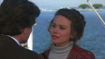Movie still from “The Unbearable Lightness of Being” (1988), directed by Philip Kaufman – A woman in a red and white jacket talking to a man in a red and white jacket; Close Up shot, Over the shoulder angle