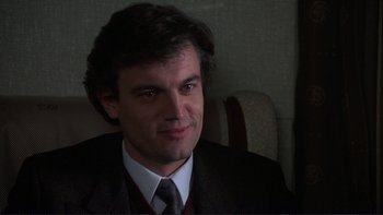 Movie still from “The Unbearable Lightness of Being” (1988), directed by Philip Kaufman – A person wearing a suit and tie; Close Up shot, Low angle