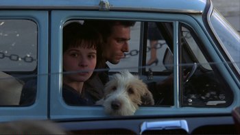 Movie still from “The Unbearable Lightness of Being” (1988), directed by Philip Kaufman – A man and a woman in a car looking out the window; Close Up shot, Low angle