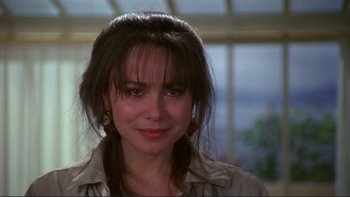 Movie still from “The Unbearable Lightness of Being” (1988), directed by Philip Kaufman – A person wearing a jacket; Close Up shot, Over the shoulder angle