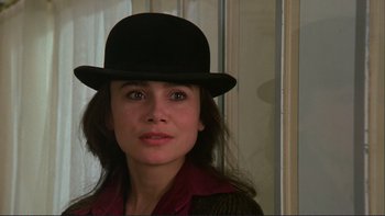 Movie still from “The Unbearable Lightness of Being” (1988), directed by Philip Kaufman – A person wearing a hat; Close Up shot, Over the shoulder angle