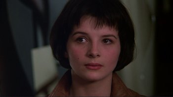 Movie still from “The Unbearable Lightness of Being” (1988), directed by Philip Kaufman – A person with short hair; Close Up shot, High angle