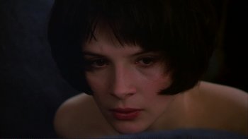 Movie still from “The Unbearable Lightness of Being” (1988), directed by Philip Kaufman – A person with short black hair; Close Up shot, High angle