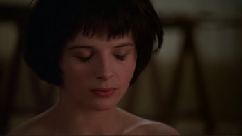 Movie still from “The Unbearable Lightness of Being” (1988), directed by Philip Kaufman – A person with short black hair; Close Up shot, High angle