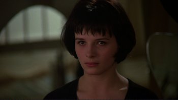 Movie still from “The Unbearable Lightness of Being” (1988), directed by Philip Kaufman – A person wearing a black shirt; Close Up shot, High angle