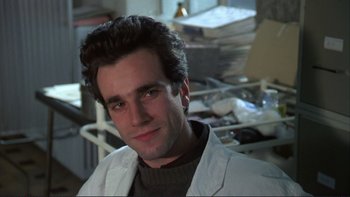 Movie still from “The Unbearable Lightness of Being” (1988), directed by Philip Kaufman – A person wearing a lab coat; Close Up shot, Low angle
