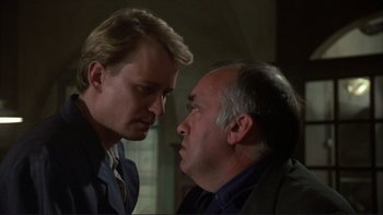 Movie still from “The Unbearable Lightness of Being” (1988), directed by Philip Kaufman – A man and another man are looking at one another; Close Up shot, Over the shoulder angle