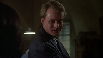 Movie still from “The Unbearable Lightness of Being” (1988), directed by Philip Kaufman – A person wearing a suit and tie; Close Up shot, Low angle