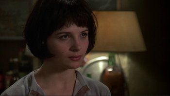 Movie still from “The Unbearable Lightness of Being” (1988), directed by Philip Kaufman – A woman with short black hair wearing a white shirt; Close Up shot, Over the shoulder angle