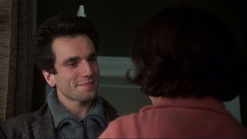 Movie still from “The Unbearable Lightness of Being” (1988), directed by Philip Kaufman – A man and a woman looking at one another in a mirror; Close Up shot, Over the shoulder angle