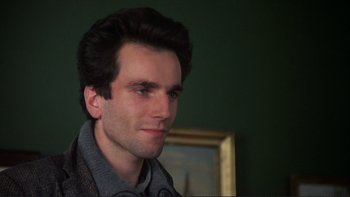 Movie still from “The Unbearable Lightness of Being” (1988), directed by Philip Kaufman – A person wearing a sweater; Close Up shot, Over the shoulder angle