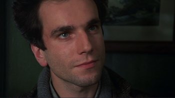 Movie still from “The Unbearable Lightness of Being” (1988), directed by Philip Kaufman – A person looking at the camera; Close Up shot, Low angle