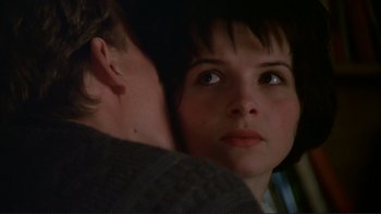 Movie still from “The Unbearable Lightness of Being” (1988), directed by Philip Kaufman – A person with their face close to the face of another person; Close Up shot, Over the shoulder angle