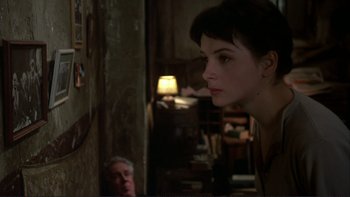 Movie still from “The Unbearable Lightness of Being” (1988), directed by Philip Kaufman – A young woman standing next to an older man in a room; Close Up shot, Over the shoulder angle