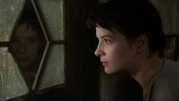A woman looking out of a window at night