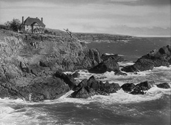 Movie still from “The Uninvited” (1944), directed by Lewis Allen – A person jumping in the air off a cliff by the ocean; Extreme Wide shot, Low angle