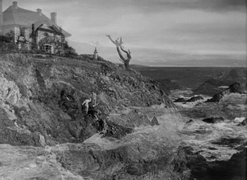 Movie still from “The Uninvited” (1944), directed by Lewis Allen – Two people standing on a cliff looking out at the ocean; Extreme Wide shot, Low angle