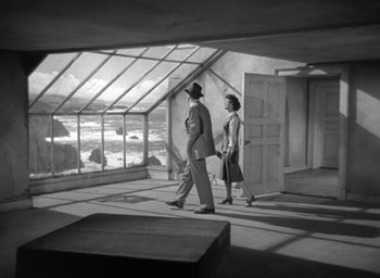 Movie still from “The Uninvited” (1944), directed by Lewis Allen – A man and a woman walking through a room; Wide shot, Low angle