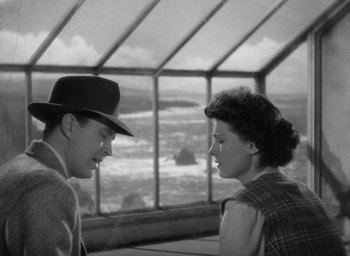 Movie still from “The Uninvited” (1944), directed by Lewis Allen – A man and a woman talking to each other; Medium shot, High angle
