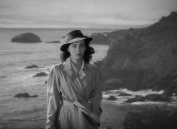 Movie still from “The Uninvited” (1944), directed by Lewis Allen – A black and white photo of a woman wearing a hat; Medium shot, High angle