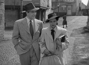 Movie still from “The Uninvited” (1944), directed by Lewis Allen – A man and a woman walking down a street; Medium shot, High angle