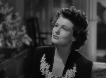 Movie still from “The Uninvited” (1944), directed by Lewis Allen – An old photo of a woman in a black dress; Close Up shot, Low angle