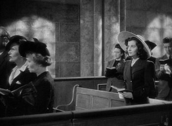 Movie still from “The Uninvited” (1944), directed by Lewis Allen – A group of women standing in front of a bench; Medium shot, Low angle