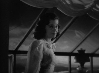 Movie still from “The Uninvited” (1944), directed by Lewis Allen – A young girl standing in front of an open window; Close Up shot, Low angle