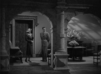 Movie still from “The Uninvited” (1944), directed by Lewis Allen – A man and a woman standing in a room; Wide shot, High angle