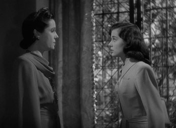 Movie still from “The Uninvited” (1944), directed by Lewis Allen – Two women standing next to each other in front of a window; Close Up shot, Over the shoulder angle