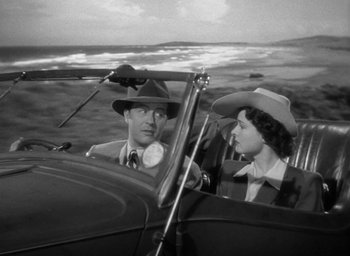 Movie still from “The Uninvited” (1944), directed by Lewis Allen – A man and a woman sitting in the back of an airplane; Medium shot, High angle