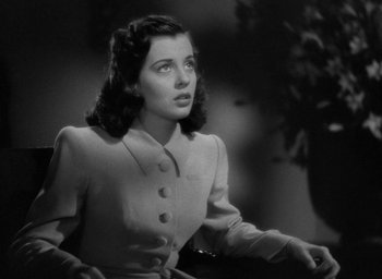 Movie still from “The Uninvited” (1944), directed by Lewis Allen – An old photo of a woman in a dress; Close Up shot, Low angle