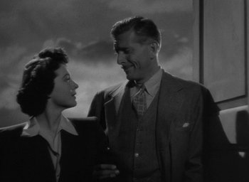 Movie still from “The Uninvited” (1944), directed by Lewis Allen – A man and a woman standing next to each other; Medium shot, Low angle
